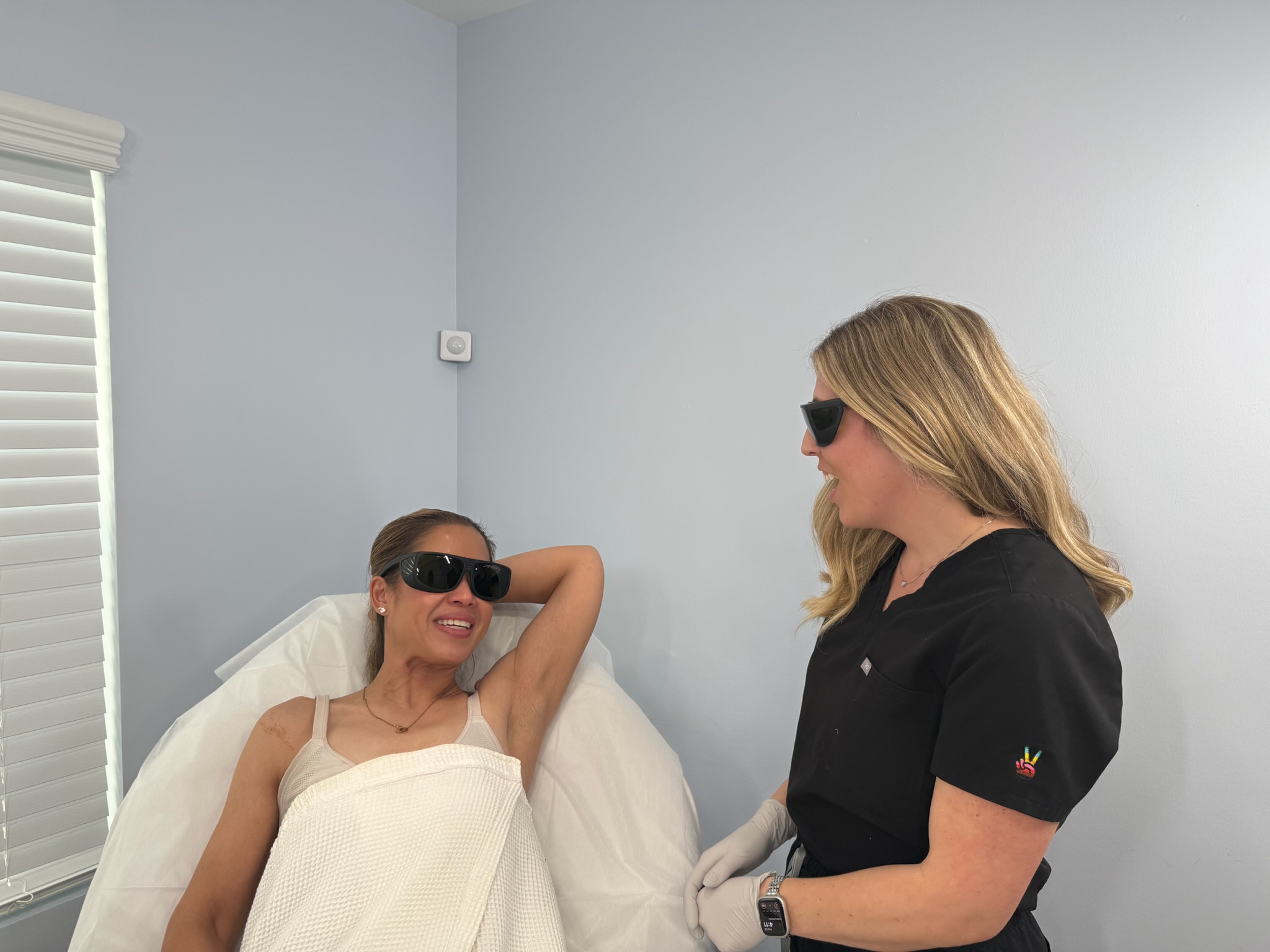 Laser Me specialist laughing with a client during a laser hair removal consultation