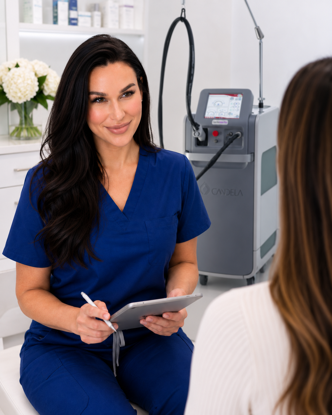 Rachel Schulte consulting with a client beside the Candela GentleMax Pro at Laser Me